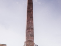 Obelisk on Alter Markt  In 1755, a Roman forefront designed by von Knobelsdorff was built for St. Nicholas Church. At the same time, this obelisk was erected. The obelisk was damaged during the last battles of World War II. In 1969 it was removed for restoration. It returned to its old place in 1979. The four antique statues at the base are still the originals, made by scupltor Gottlieb Heymüller. The four medallions at the bottom of the obelisk, one on each side, originally depicted Prussian kings. After the war, when the House of Hohenzollern had fallen out of favor in East Germany, they were changed to depict four of Potsdam's most influential architects: Karl Friedrich Schinkel, Georg Wenzeslaus von Knobelsdorff, Friedrich Ludwig Persius and Carl Phillip Christian von Gontard. : 2016, Brandenburg, DEU, Fujifilm, Germany, Potsdam, digital image, historia, history, kaupunki, kesäloma, matka, summer holiday, town, travel