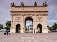 Brandenburger Tor  The Brandenburg Gate was built in 1770/71 by Carl von Gontard and Georg Christian Unger by order of Frederick II of Prussia. It stands at the western end of Brandenburger Straße, which runs in a straight line up to the Church of St. Peter and St. Paul. Previously, from 1733, there was another, simpler gate on the same spot, which resembled a castle gateway. Together with the city wall, a form of toll or excise barrier, and the other gates it was intended to prevent desertion and smuggling. Towards the end of the Seven Years' War, Frederick the Great had the old gate demolished and built, in its stead, this new Brandenburg Gate, as a symbol of his victory. For that reason the Brandenburg Gate resembles a Roman triumphal arch. Its prototype was the Arch of Constantine in Rome. The Roman influence of its architectural style can be seen, for example, in the double columns of Corinthian order as well as the design of the attic. A feature of the Brandenburg Gate is that it has two completely different sides, designed by two architects. Carl von Gontard designed the city side, his pupil, Georg Christian Unger, the field or countryside-facing side. Gontard made the city side as a rendered facade with Corinthian-style lesenes and trophies, Unger designed the field site in the style of the Arch of Constantine with Corinthian double-columns and ornamentation like the golden trumpets. The two side entrances for pedestrians were not added until 1843, under Frederick William IV, in order to cope with the increase in pedestrian traffic : 2016, Brandenburg, DEU, Fujifilm, Germany, Potsdam, digital image, historia, history, kaupunki, kesäloma, matka, summer holiday, town, travel