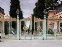 Park Sanssouci  The Green Gate (German: Grünes Gitter) is the main gateway into Sanssouci Park and is situated at the end of the avenue to Sanssouci Palace. This begins as one of three roads that radiate from the Luisenplatz square. The gate was designed by Ludwig Ferdinand Hesse and was put up in 1854 as part of the construction of the Church of Peace. Its name comes from the colour in which the gate was painted. Additional ornamentation is provided by individual bars and points being picked up in gold leaf. The iron gate bears the initials of Frederick William IV. : 2016, Brandenburg, DEU, Fujifilm, Germany, Potsdam, digital image, historia, history, kaupunki, kesäloma, matka, summer holiday, town, travel