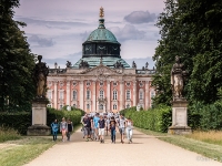 Neues Palais  The New Palace is a palace situated on the western side of the Sanssouci park. The building was begun in 1763, after the end of the Seven Years' War, under King Friedrich II (Frederick the Great) and was completed in 1769. It is considered to be the last great Prussian baroque palace. After the death of Frederick the Great in 1786, the New Palace fell into disuse and was rarely occupied as a residence or entertainment venue. However, starting in 1859 it became the summer residence of the German Crown Prince, Frederick William, later German Emperor Frederick III. The palace was the preferred residence of Frederick and his empress, Victoria, throughout the 99 Days’ Reign. During the short reign of Frederick III, the palace was renamed "Friedrichskron Palace" (Schloss Friedrichskron) and a moat was dug around the palace. The ascension of Wilhelm II saw renovation and restoration within the palace being carried out with the installation of steam heating, bathrooms in state apartments and electrification of the chandeliers which Frederick the Great had collected from across Europe. Until 1918, it remained the preferred residence of Wilhelm II and the Empress Augusta. : 2016, Fujifilm, Potsdam, digital image, historia, history, kaupunki, kesäloma, matka, summer holiday, town, travel