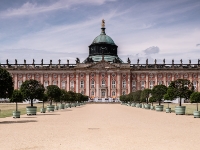 Neues Palais  The New Palace is a palace situated on the western side of the Sanssouci park. The building was begun in 1763, after the end of the Seven Years' War, under King Friedrich II (Frederick the Great) and was completed in 1769. It is considered to be the last great Prussian baroque palace. After the death of Frederick the Great in 1786, the New Palace fell into disuse and was rarely occupied as a residence or entertainment venue. However, starting in 1859 it became the summer residence of the German Crown Prince, Frederick William, later German Emperor Frederick III. The palace was the preferred residence of Frederick and his empress, Victoria, throughout the 99 Days’ Reign. During the short reign of Frederick III, the palace was renamed "Friedrichskron Palace" (Schloss Friedrichskron) and a moat was dug around the palace. The ascension of Wilhelm II saw renovation and restoration within the palace being carried out with the installation of steam heating, bathrooms in state apartments and electrification of the chandeliers which Frederick the Great had collected from across Europe. Until 1918, it remained the preferred residence of Wilhelm II and the Empress Augusta. : 2016, Fujifilm, Potsdam, digital image, historia, history, kaupunki, kesäloma, matka, summer holiday, town, travel