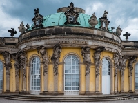 Sanssouci Palace  Sanssouci is the former summer palace of Frederick the Great, King of Prussia, in Potsdam, near Berlin. It is often counted among the German rivals of Versailles. While Sanssouci is in the more intimate Rococo style and is far smaller than its French Baroque counterpart, it too is notable for the numerous temples and follies in the park. The palace was designed/built by Georg Wenzeslaus von Knobelsdorff between 1745 and 1747 to fulfill King Frederick's need for a private residence where he could relax away from the pomp and ceremony of the Berlin court. The palace's name emphasises this; it is a French phrase (sans souci), which translates as "without concerns", meaning "without worries" or "carefree", symbolising that the palace was a place for relaxation rather than a seat of power. Sanssouci is little more than a large, single-story villa—more like the Château de Marly than Versailles. Containing just ten principal rooms, it was built on the brow of a terraced hill at the centre of the park. The influence of King Frederick's personal taste in the design and decoration of the palace was so great that its style is characterised as "Frederician Rococo", and his feelings for the palace were so strong that he conceived it as "a place that would die with him". Because of a disagreement about the site of the palace in the park, Knobelsdorff was fired in 1746. Jan Bouman, a Dutch architect, finished the project : 2016, Fujifilm, Potsdam, digital image, historia, history, kaupunki, kesäloma, matka, summer holiday, town, travel