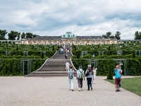 Sanssouci Palace  Sanssouci is the former summer palace of Frederick the Great, King of Prussia, in Potsdam, near Berlin. It is often counted among the German rivals of Versailles. While Sanssouci is in the more intimate Rococo style and is far smaller than its French Baroque counterpart, it too is notable for the numerous temples and follies in the park. The palace was designed/built by Georg Wenzeslaus von Knobelsdorff between 1745 and 1747 to fulfill King Frederick's need for a private residence where he could relax away from the pomp and ceremony of the Berlin court. The palace's name emphasises this; it is a French phrase (sans souci), which translates as "without concerns", meaning "without worries" or "carefree", symbolising that the palace was a place for relaxation rather than a seat of power. Sanssouci is little more than a large, single-story villa—more like the Château de Marly than Versailles. Containing just ten principal rooms, it was built on the brow of a terraced hill at the centre of the park. The influence of King Frederick's personal taste in the design and decoration of the palace was so great that its style is characterised as "Frederician Rococo", and his feelings for the palace were so strong that he conceived it as "a place that would die with him". Because of a disagreement about the site of the palace in the park, Knobelsdorff was fired in 1746. Jan Bouman, a Dutch architect, finished the project : 2016, Fujifilm, Potsdam, digital image, historia, history, kaupunki, kesäloma, matka, summer holiday, town, travel