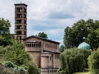 Friedenskirche  The church was built according to the wishes and with the close involvement of the artistically gifted King Frederick William IV and designed by the court architect, Ludwig Persius. After Persius' death in 1845, the architect Friedrich August Stüler was charged with continuing his work. Building included work by Ferdinand von Arnim and Ludwig Ferdinand Hesse also. The church is located in the area covered by the UNESCO World Heritage Site Palaces and Parks of Potsdam and Berlin. The cornerstone of the churchhouse was laid on April 14, 1845. The building was dedicated on September 24, 1848, though construction continued until 1854. The structure resembles a High Medieval Italian monastery. An original Venetian mosaic from the early 13th century decorates the church's apse. While he was crown prince Frederick William had it bought at auction for 385 thalers and brought to Potsdam by boat. The mosaic shows the enthroned Christ with the Book of Life, the right hand upheld in blessing. At each side stand Mary and John the Baptist. Next to them stand the apostle Peter and Saint Cyprian, martyred by beheading in 258 and patron saint of Saint Cipriana, wearing chasubles. As an allegory for the Holy Spirit, a pigeon decorates the vertex of the hemisphere. Over the heads of the archangels Raphael and Michael a lamb shines as a symbol of Christ. On the semicircle of the apse a Latin inscript reads, according to Martin Luther's translation: "Lord, I have love for the site of your house and the place where your glory resides". The Kaiser Friedrich Mausoleum was added to the north side between 1888 and 1890. The plans were drawn up by Julius Carl Raschdorff (de), who also designed the Berlin Cathedral from 1893 to 1905, in the style of the Baroque-influenced Italian High Renaissance. The 17th century Chapel of the Holy Tomb in Innichen, South Tyrol, Italy serves as an archetype for the mausoleum. : 2016, Fujifilm, Potsdam, digital image, historia, history, kaupunki, kesäloma, matka, summer holiday, town, travel