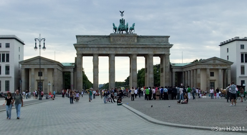berlin-22.jpg - The Brandenburg Gate (German: Brandenburger Tor) is a former city gate and one of the main symbols of Berlin and Germany. It is located west of the city center at the junction of Unter den Linden and Ebertstraße. It is the only remaining gate of a series through which Berlin was once entered. It was commissioned by King Frederick William II of Prussia as a sign of peace and built by Carl Gotthard Langhans from 1788 to 1791.