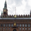 Copenhagen City Hall (Danish: Københavns Rådhus) is the headquarters of the municipal council as well as the Lord mayor of the Copenhagen Municipality, Denmark.<br />The current building was inaugurated in 1905. It was designed by the architect Martin Nyrop in the National Romantic style. It is dominated by its richly ornamented front, the gilded statue of Absalon just above the balcony and the tall, slim clock tower. The latter is at 105.6 metres one of the tallest buildings in the  city of Copenhagen.<br />In addition to the tower clock, the City Hall also houses Jens Olsen's World Clock.