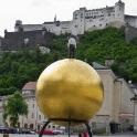This sphere is part of a piece of art by Stephan Balkenhol and was arranged on the Kapitelplatz as one project in a series. Salzburg castle in the background.