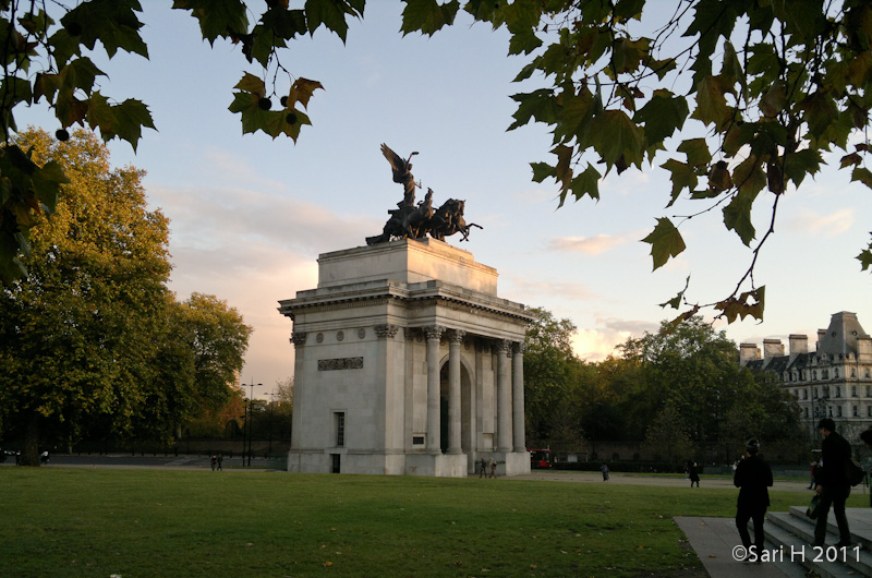 01112011760.jpg - Wellington Arch, also known as Constitution Arch or (originally) the Green Park Arch, is a triumphal arch located to the south of Hyde Park in central London and at the north western corner of Green Park (although it is now isolated on a traffic island). It was built between 1826-1830 to a design by Decimus Burton. Much of the intended exterior ornamentation was omitted as a cost-saving exercise. In 1846 the arch was selected as a location for a statue of Arthur Wellesley, 1st Duke of Wellington. In 1882-3, the arch was moved a short distance to its present location on Hyde Park Corner to facilitate a road widening scheme. The Wellington Statue was removed to Aldershot at the same time and was eventually replaced, in 1912, by a huge bronze quadriga designed by Adrian Jones. (Wikipedia)