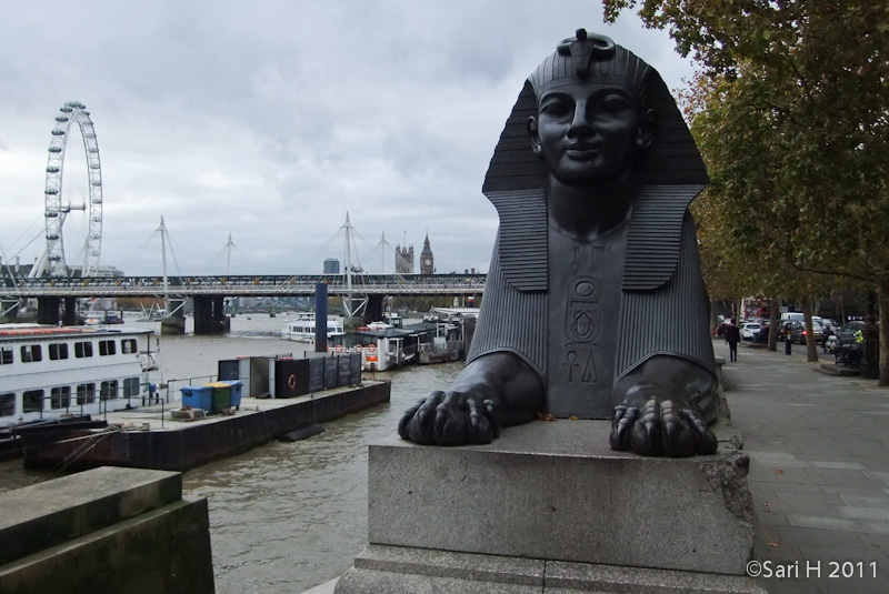 DSCF2740.jpg - Cleopatra's Needle is flanked by two faux-Egyptian sphinxes cast from bronze that bear hieroglyphic inscriptions that say netjer nefer men-kheper-re di ankh (the good god, Thuthmosis III given life). These Sphinxes appear to be looking at the Needle rather than guarding it. This is due to the Sphinxes' improper or backwards installation. Here's one of those sphinxes. 