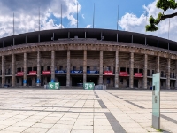 Olympic Stadium  The Olympiastadion was originally built for the 1936 Summer Olympics by Werner March. During the Olympics, the record attendance was thought to be over 100,000. Today the stadium is part of the Olympiapark Berlin. When the Nazis came to power in Germany (1933), they decided to use the Olympic Games in 1936 for propaganda purposes. With these plans in mind, Adolf Hitler ordered the construction of a great sports complex in Grunewald named the "Reichssportfeld" with a totally new Olympiastadion. Architect Werner March remained in charge of the project, assisted by his brother Walter. Construction took place from 1934 to 1936. When the Reichssportfeld was finished, it was 1.32 square kilometres. It consisted of (east to west): the Olympiastadion, the Maifeld (Mayfield, capacity of 50,000) and the Waldbühne amphitheater (capacity of 25,000), in addition to various places, buildings and facilities for different sports (such as football, swimming, equestrian events, and field hockey) in the northern part. : 2016, Berliini, Berlin, Fujifilm, Germany, Saksa, digital image, historia, history, kaupunki, kesäloma, matka, summer holiday, town, travel