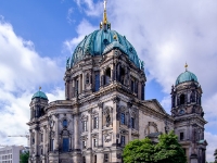 Berliner Dom  With no separation of Protestant church and state of Prussia, Wilhelm II officiated as the summus episcopus (Supreme Governor of the Evangelical State Church of Prussia's older Provinces, as it was named since 1875) and the state paid the complete construction cost of 11,5 million Marks. At 114 metres long, 73 metres wide and 116 metres tall, it was much larger than any of the previous buildings and was considered a Protestant counterweight to St. Peter's Basilica in Vatican City. On 27 February 1905 the present building was inaugurated. It is built by Julius and Otto Raschdorff, father and son. In 1940 the blast waves of Allied bombing blew part of the windows away. On 24 May 1944, a bomb of combustible liquids entered the roof lantern of the dome. The fire could not be extinguished at that unreachable section of the dome. So the lantern burnt out and collapsed into the main floor. Between 1949 and 1953 a temporary roof was built to enclose the building. On 9 May 1967 the then still undivided Evangelical Church of the Union decided a committee for the reconstruction of the Supreme Parish and Cathedral Church, then located in East Berlin. The government of the Eastern German Democratic Republic did not oppose the work of the committee due to the concomitant inflow of Deutsche Marks. In 1975 reconstruction started, simplifying the building's original design and demolishing the northern wing, the 'Denkmalskirche' – Memorial Church. Compared by some to the Medici Chapel, it had survived the war completely intact, but astonishingly, was demolished purely for ideological reasons by the communist government due to it being a hall of honour for the Hohenzollern dynasty. It resulted in the surreal circumstance of scaffolding for restoration appearing on the church while detonation charges were applied to its undamaged rear. The government also demanded the removal of as many crosses as possible. The demolition and redesign cost 800,000 marks, while the restoration (done on the cheap) cost just 50,000 marks.[11] The Berlin Cathedral Building Society now seek to rebuild the Denkmalskirche. : 2016, Berliini, Berlin, Fujifilm, digital image, kaupunki, kesäloma, summer holiday, town