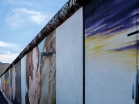 East Side Gallery  The East Side Gallery is an international memorial for freedom. It is a 1.3 km long section of the Berlin Wall located near the centre of Berlin on Mühlenstraße in Friedrichshain-Kreuzberg. The actual border at this point was the river Spree. The gallery is located on the so-called "hinterland mauer", which closed the border to West Berlin. The Gallery consists of 105 paintings by artists from all over the world, painted in 1990 on the east side of the Berlin Wall. The East Side Gallery was founded following the successful merger of the two German artists' associations VBK and BBK. The founding members were the speche of the Federal Association of Artists BBK Bodo Sperling, Barbara Greul Aschanta, Jörg Kubitzki and David Monti. It is possibly the largest and longest-lasting open air gallery in the world. Paintings from Jürgen Grosse alias INDIANO, Dimitri Vrubel, Siegfrid Santoni, Bodo Sperling, Kasra Alavi, Kani Alavi, Jim Avignon, Thierry Noir, Ingeborg Blumenthal, Ignasi Blanch i Gisbert, Kim Prisu, Hervé Morlay VR and others have followed. : 2016, Berliini, Berlin, Fujifilm, digital image, kaupunki, kesäloma, summer holiday, town