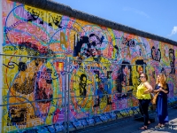 East Side Gallery  The East Side Gallery is an international memorial for freedom. It is a 1.3 km long section of the Berlin Wall located near the centre of Berlin on Mühlenstraße in Friedrichshain-Kreuzberg. The actual border at this point was the river Spree. The gallery is located on the so-called "hinterland mauer", which closed the border to West Berlin. The Gallery consists of 105 paintings by artists from all over the world, painted in 1990 on the east side of the Berlin Wall. The East Side Gallery was founded following the successful merger of the two German artists' associations VBK and BBK. The founding members were the speche of the Federal Association of Artists BBK Bodo Sperling, Barbara Greul Aschanta, Jörg Kubitzki and David Monti. It is possibly the largest and longest-lasting open air gallery in the world. Paintings from Jürgen Grosse alias INDIANO, Dimitri Vrubel, Siegfrid Santoni, Bodo Sperling, Kasra Alavi, Kani Alavi, Jim Avignon, Thierry Noir, Ingeborg Blumenthal, Ignasi Blanch i Gisbert, Kim Prisu, Hervé Morlay VR and others have followed. : 2016, Berliini, Berlin, Fujifilm, digital image, kaupunki, kesäloma, summer holiday, town