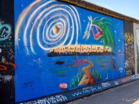 East Side Gallery  The East Side Gallery is an international memorial for freedom. It is a 1.3 km long section of the Berlin Wall located near the centre of Berlin on Mühlenstraße in Friedrichshain-Kreuzberg. The actual border at this point was the river Spree. The gallery is located on the so-called "hinterland mauer", which closed the border to West Berlin. The Gallery consists of 105 paintings by artists from all over the world, painted in 1990 on the east side of the Berlin Wall. The East Side Gallery was founded following the successful merger of the two German artists' associations VBK and BBK. The founding members were the speche of the Federal Association of Artists BBK Bodo Sperling, Barbara Greul Aschanta, Jörg Kubitzki and David Monti. It is possibly the largest and longest-lasting open air gallery in the world. Paintings from Jürgen Grosse alias INDIANO, Dimitri Vrubel, Siegfrid Santoni, Bodo Sperling, Kasra Alavi, Kani Alavi, Jim Avignon, Thierry Noir, Ingeborg Blumenthal, Ignasi Blanch i Gisbert, Kim Prisu, Hervé Morlay VR and others have followed. : 2016, Berliini, Berlin, Fujifilm, digital image, kaupunki, kesäloma, summer holiday, town