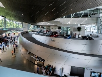 BMW Welt  BMW Welt operations are coordinated with the other local BMW facilities, the BMW Museum and BMW Headquarters. It has a showroom with the current model lineup of BMW cars and motorcycles, and the other two BMW Group brands, Mini and Rolls-Royce. Customers picking up special ordered cars are given a dramatic "staged experience" in which they await their new car in an enormous glass-walled hall, and their cars are lifted up from lower levels on round elevator platforms. BMW Welt also has shops selling BMW-branded promotional merchandise and accessories, and a restaurant. The contract was awarded to the Vienna-based architects COOP HIMMELB(L)AU and the facility was constructed from August 2003 through summer 2007 at a cost of US$200 million. Originally conceived to be open and ready for World Cup 2006, it eventually opened on October 17, 2007, and deliveries commenced on October 23, 2007. : 2016, BMW, BMW Museum, BMW Welt, Fujifilm, LG G3, Munich, München, car, digital image, historia, history, kesäloma, matka, motorbike, phone image, summer holiday, travel