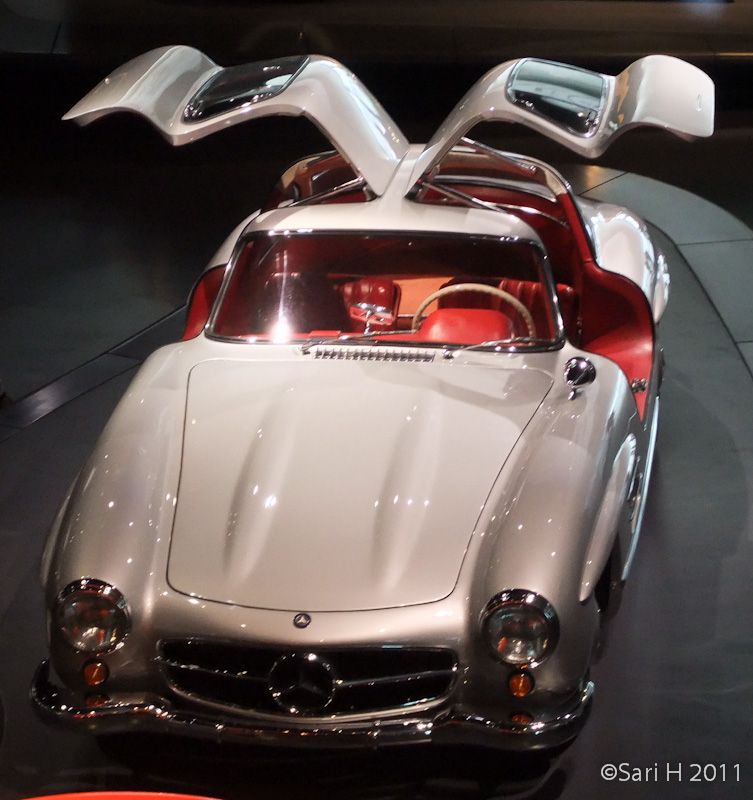 merc_museum-29.jpg - 1955 Mercedes-Benz 300 SL Coupé. It was based on the competition version of 1952. Normal doors were not possible because of the high frame side members, thus upward-opening doors. These doors gave it it's nickname, "Gullwing". 215 hp, 250 km/h